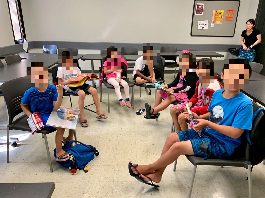 Children reading picturebooks on their own during a book club session