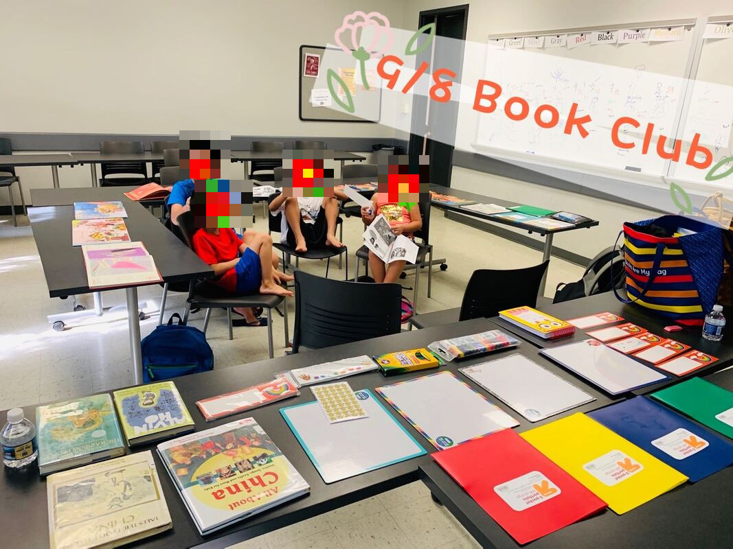 Book club session with picturebooks and writing materials laid out on the tables